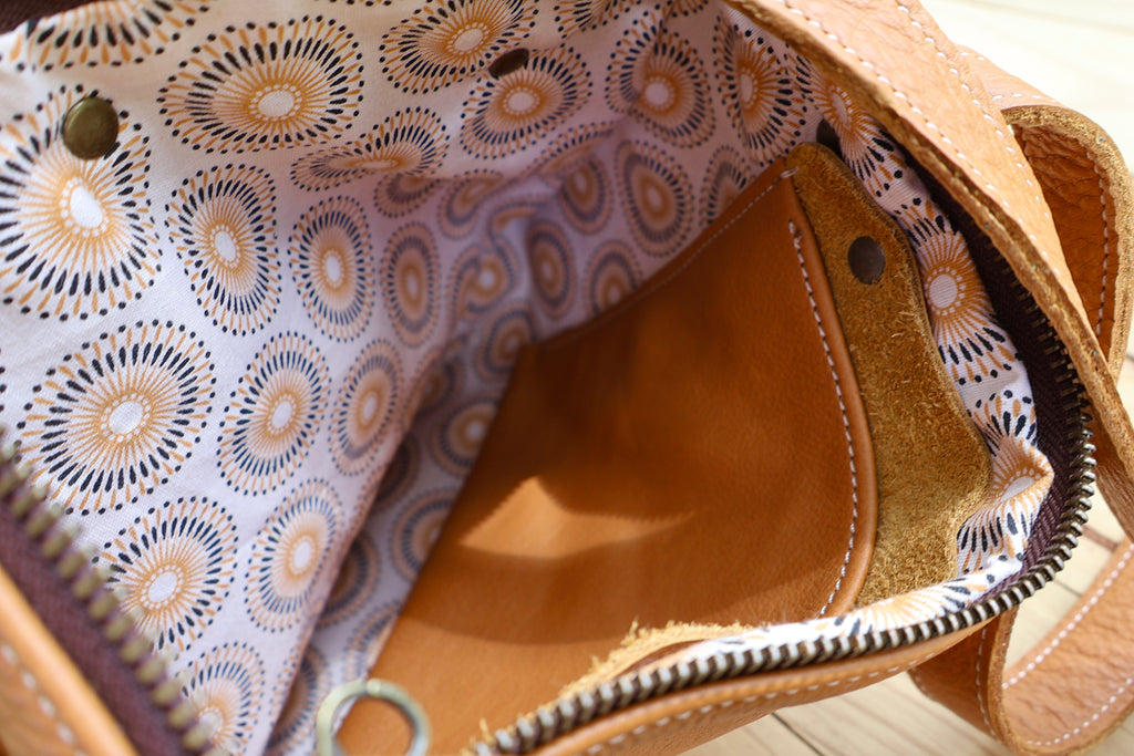 Baobab Tote– A classic leather tote featuring a functional top zip closure and a front pocket, beautifully lined with Shwe Shwe fabric